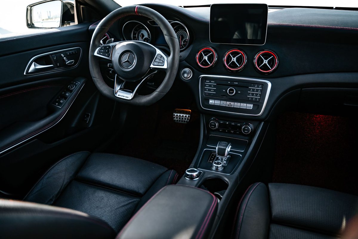 Clean black leather interior with red accents